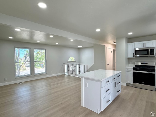 445 Havasu, Tooele, UT 84074 - kitchen with appliances with stainless steel finishes, light wood-style flooring, open floor plan, recessed lighting, and baseboards