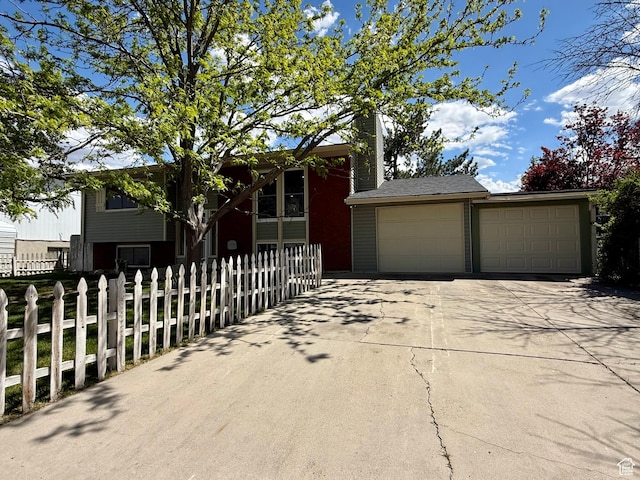 445 Havasu, Tooele, UT 84074 - view of front of home with a fenced front yard and a detached garage