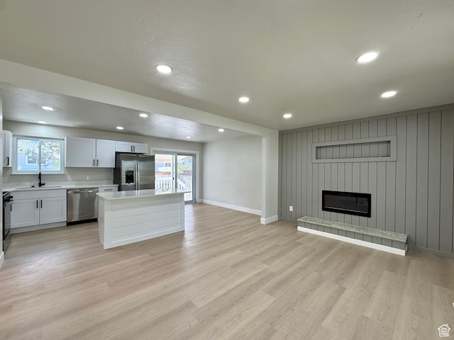 445 Havasu, Tooele, UT 84074 - kitchen featuring appliances with stainless steel finishes, light countertops, a center island, open floor plan, and light wood-style floors