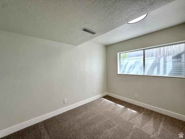 445 Havasu, Tooele, UT 84074 - spare room featuring baseboards, dark colored carpet, and a textured ceiling