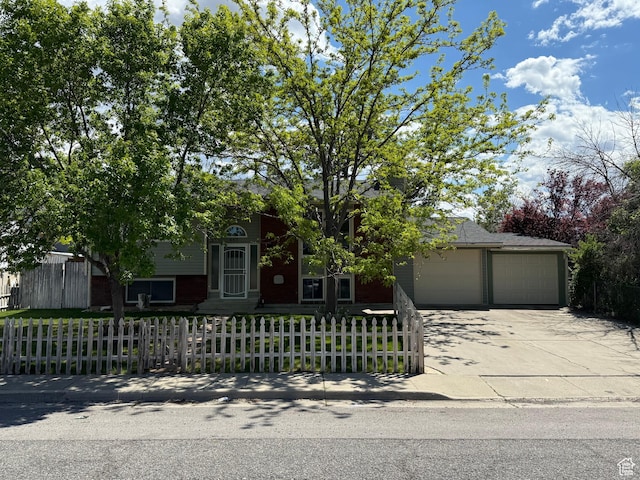 445 Havasu, Tooele, UT 84074 - obstructed view of property featuring a garage, a fenced front yard, and concrete driveway