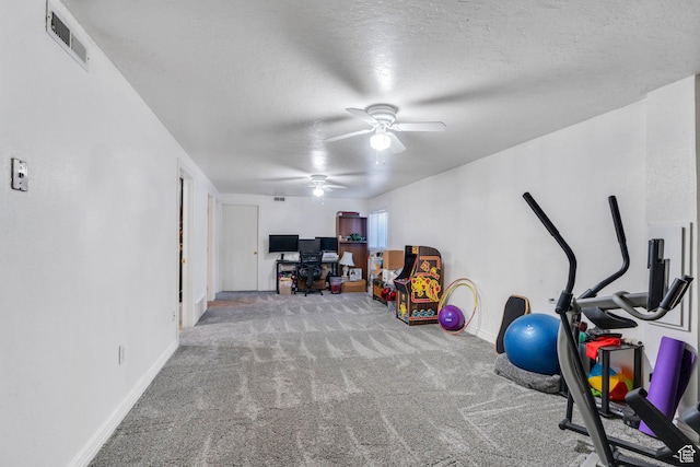 workout room featuring carpet, a ceiling fan, baseboards, and a textured ceiling
