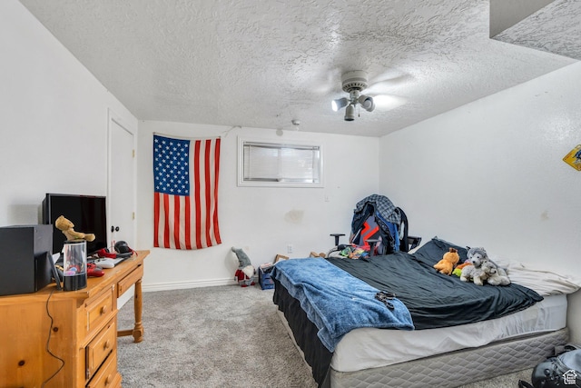 bedroom with carpet floors, a textured ceiling, baseboards, and a ceiling fan