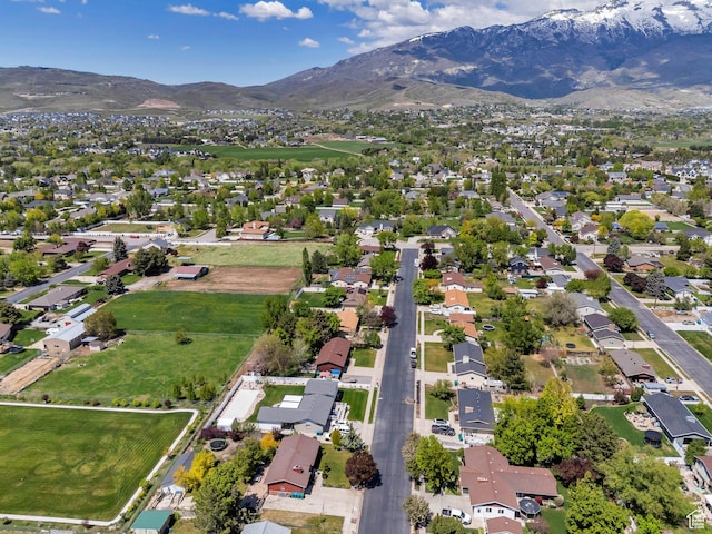 aerial overview of property's location featuring a mountain backdrop and nearby suburban area