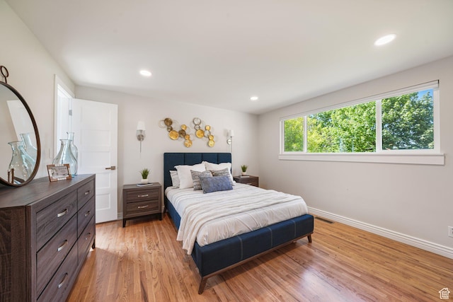 bedroom with light wood-style floors, baseboards, and recessed lighting