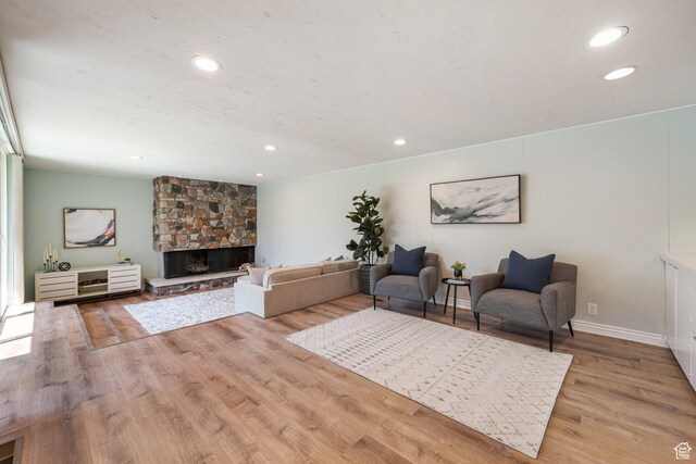3501 E Loren Von Dr, Millcreek, UT 84124 - living area with a stone fireplace, wood finished floors, and recessed lighting