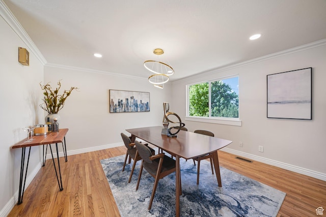dining space featuring ornamental molding, light wood-type flooring, baseboards, and recessed lighting