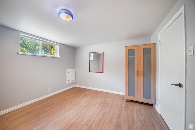 empty room with light wood-style floors and baseboards