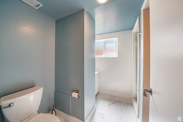 bathroom with marble look tiles, toilet, a shower stall, and baseboards