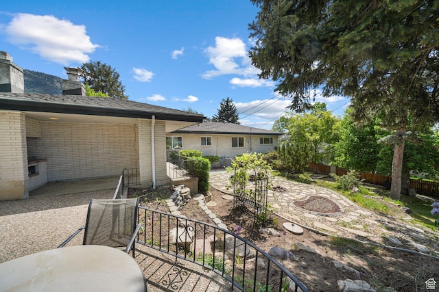 view of yard with fence, stairs, and a patio area