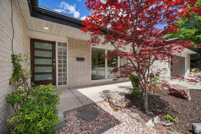 3501 E Loren Von Dr, Millcreek, UT 84124 - property entrance featuring brick siding and an attached garage