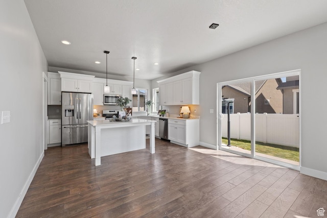 kitchen with stainless steel appliances, dark wood-style flooring, white cabinets, baseboards, and recessed lighting