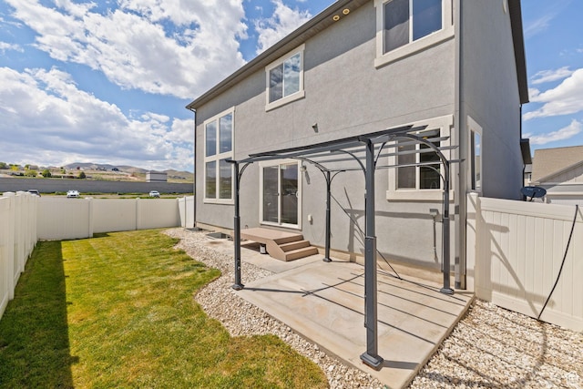 back of house with a patio area, stucco siding, and a pergola