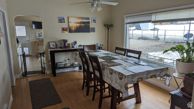1341 E Creek Rd, Cottonwood Heights, UT 84093 - dining space with ceiling fan, healthy amount of natural light, wood finished floors, and arched walkways