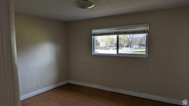 1341 E Creek Rd, Cottonwood Heights, UT 84093 - empty room with wood finished floors, baseboards, and a textured ceiling