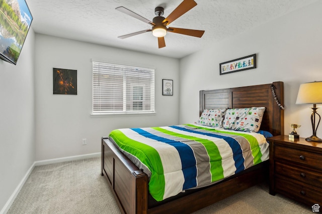 bedroom with baseboards, carpet floors, a textured ceiling, and a ceiling fan