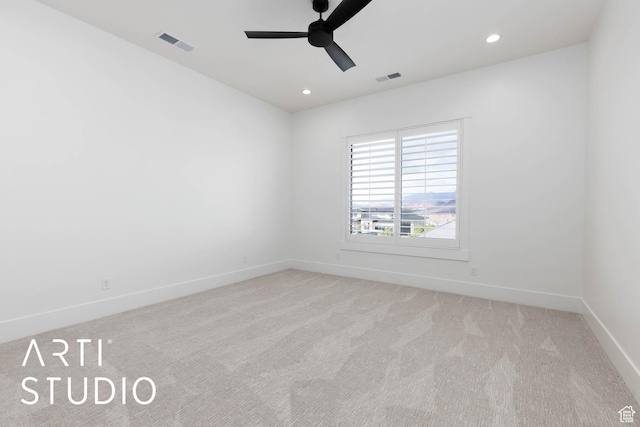 unfurnished room featuring a ceiling fan, light colored carpet, baseboards, and recessed lighting