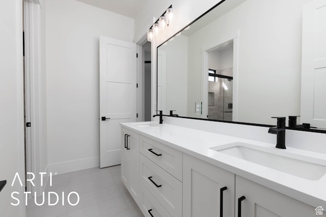 bathroom featuring a shower stall, double vanity, tile patterned flooring, and baseboards
