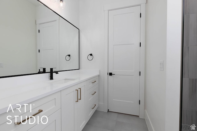 bathroom featuring vanity, baseboards, and tile patterned flooring