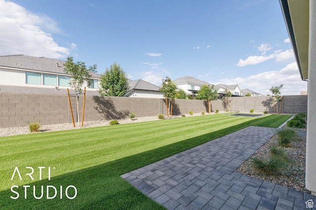 view of yard featuring a residential view and a patio area