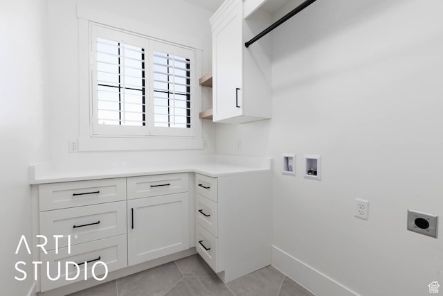 laundry room with hookup for an electric dryer, cabinet space, hookup for a washing machine, light tile patterned flooring, and baseboards