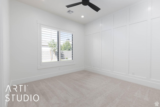 carpeted empty room with a decorative wall, a ceiling fan, baseboards, and recessed lighting