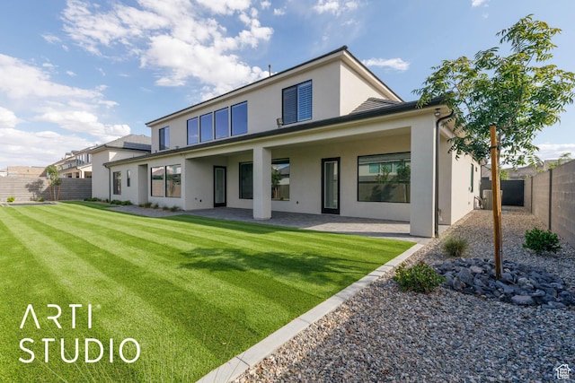 rear view of property with stucco siding and a patio area