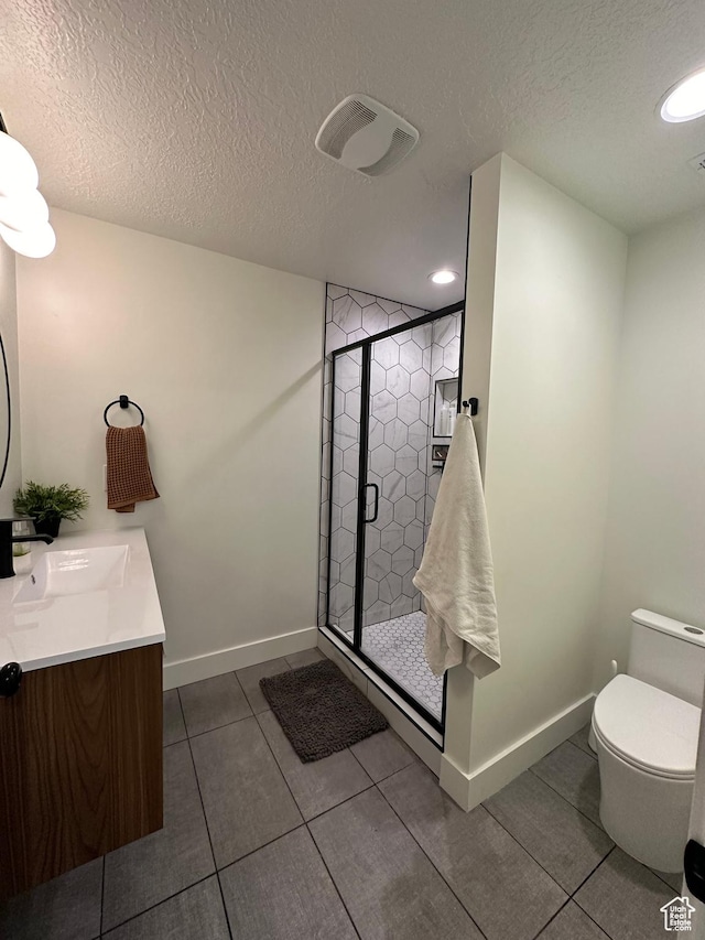 4901 N Eagle Nest Ln, Lehi, UT 84043 - bathroom with a textured ceiling, tile patterned flooring, a shower stall, toilet, and double vanity