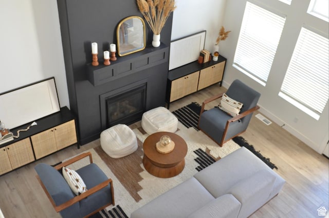 4901 N Eagle Nest Ln, Lehi, UT 84043 - living area featuring wood finished floors, healthy amount of natural light, baseboards, and a large fireplace