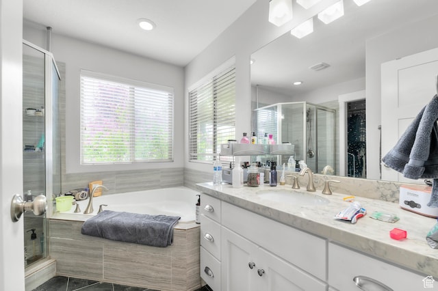bathroom featuring a shower stall, a garden tub, vanity, and recessed lighting