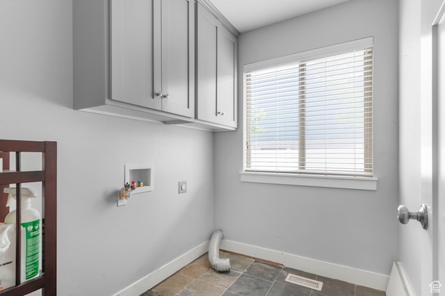 laundry room featuring hookup for an electric dryer, hookup for a washing machine, baseboards, and cabinet space