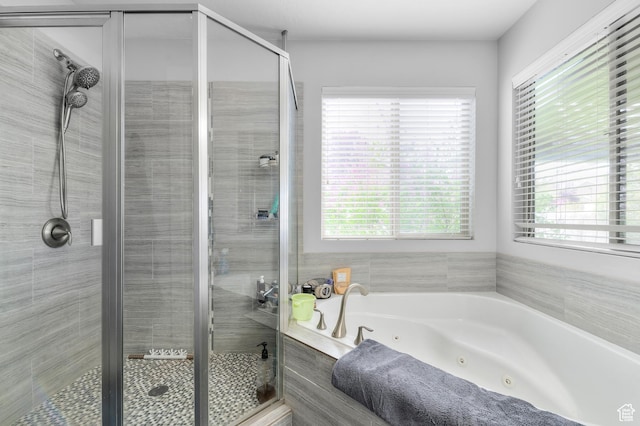 full bathroom featuring a jetted tub and a stall shower