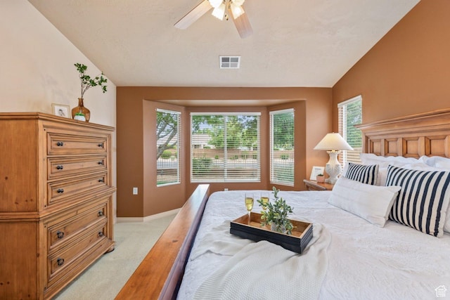 bedroom featuring light carpet, vaulted ceiling, baseboards, and a ceiling fan