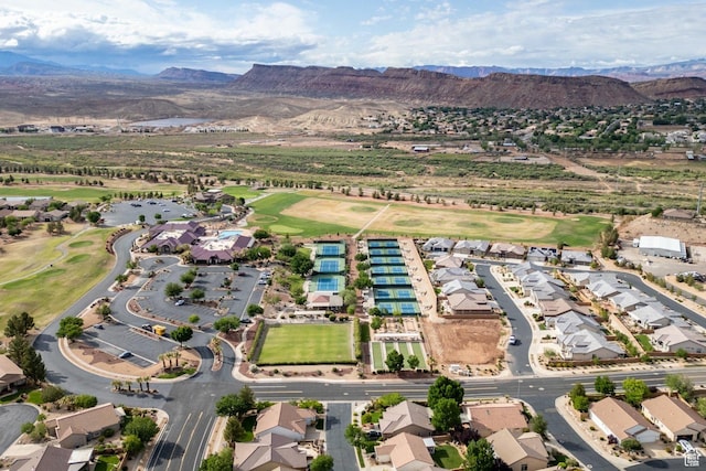 aerial view of property's location featuring a local golf course and nearby suburban area