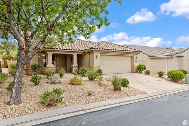 view of front facade featuring an attached garage, a tiled roof, driveway, stucco siding, and a porch