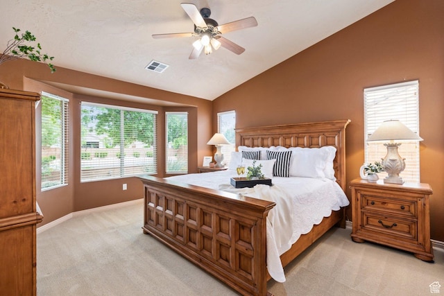 bedroom with light carpet, vaulted ceiling, baseboards, and a ceiling fan