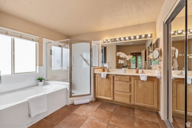 bathroom with a stall shower, vanity, and a bath