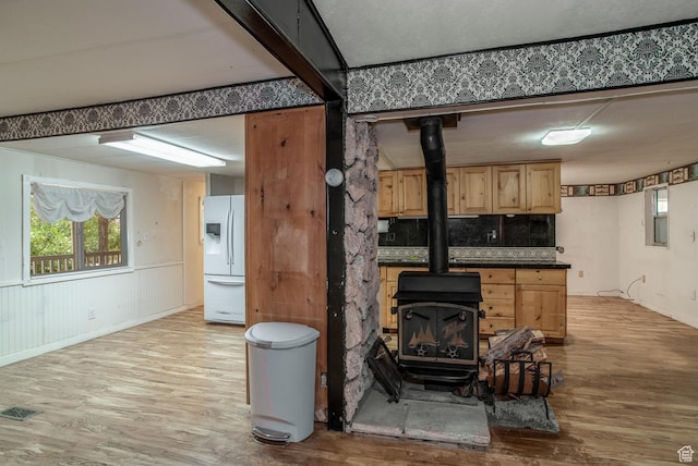 345 N Main St, Ivins, UT 84738 - living room featuring a wood stove and light wood-style floors