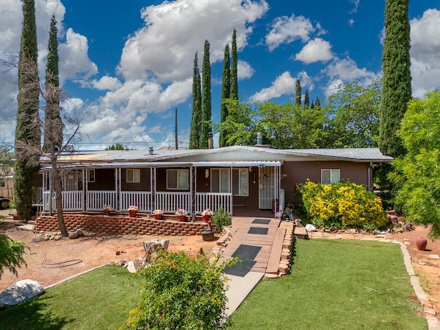 345 N Main St, Ivins, UT 84738 - view of front of house featuring a porch, a front lawn, and stucco siding