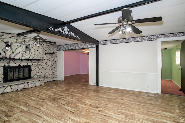 345 N Main St, Ivins, UT 84738 - unfurnished living room with a ceiling fan, wood finished floors, beamed ceiling, a fireplace, and wainscoting