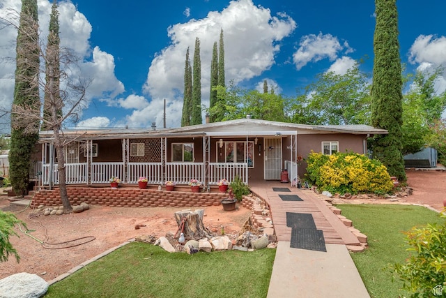 345 N Main St, Ivins, UT 84738 - view of front of property with a porch, a front yard, and stucco siding
