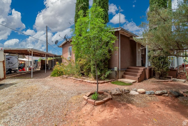 345 N Main St, Ivins, UT 84738 - view of front facade with a carport, driveway, and stucco siding