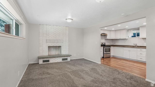 906 N Fort Canyon Rd, Alpine, UT 84004 - unfurnished living room with light colored carpet, a sink, baseboards, and recessed lighting