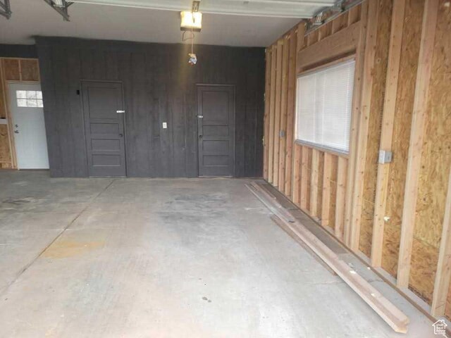 4520 S Ridgeline Dr, Washington Terrace, UT 84405 - garage featuring wood walls and a garage door opener