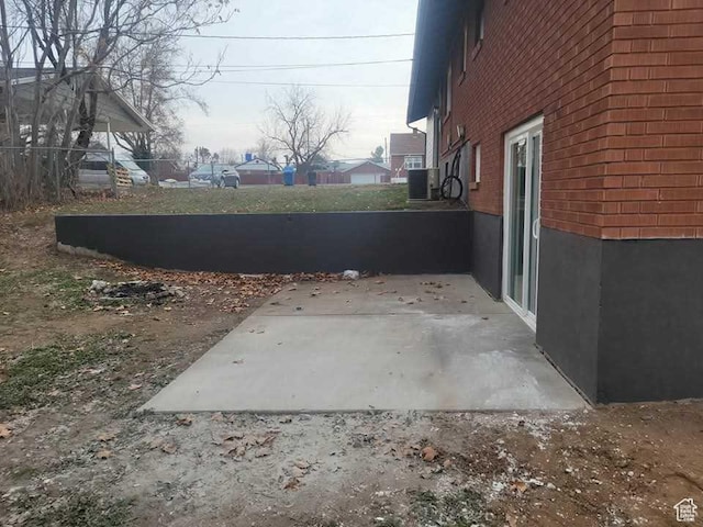 4520 S Ridgeline Dr, Washington Terrace, UT 84405 - view of property exterior featuring a patio, brick siding, and cooling unit