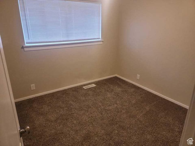 4520 S Ridgeline Dr, Washington Terrace, UT 84405 - empty room with dark colored carpet, baseboards, and plenty of natural light