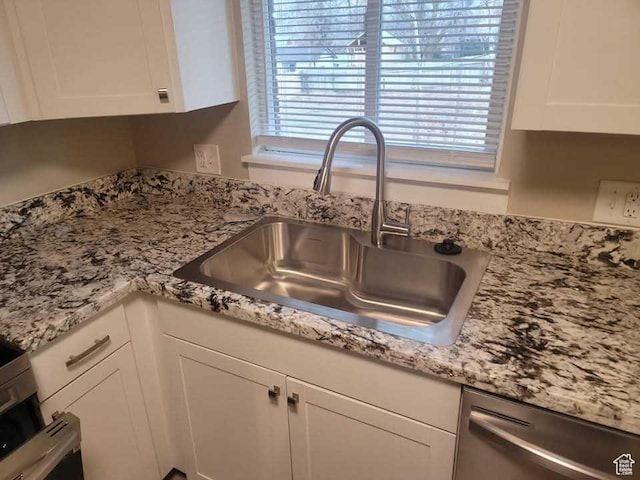 4520 S Ridgeline Dr, Washington Terrace, UT 84405 - kitchen view of a sink, stainless steel dishwasher, white cabinets, and light stone countertops