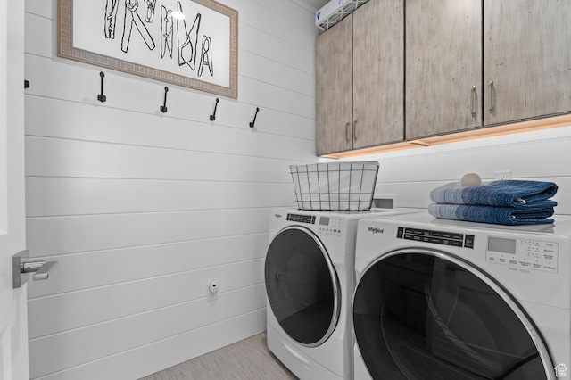 laundry room featuring cabinet space and washing machine and clothes dryer