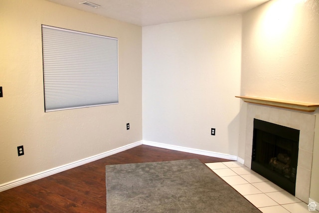 147 W 600 N Unit 111, Tooele, UT 84074 - unfurnished living room with a tiled fireplace, wood finished floors, and baseboards