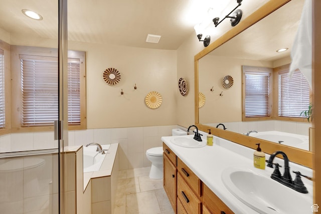8135 S Clover Spring Ln E, Cottonwood Heights, UT 84121 - bathroom featuring toilet, a garden tub, double vanity, and recessed lighting